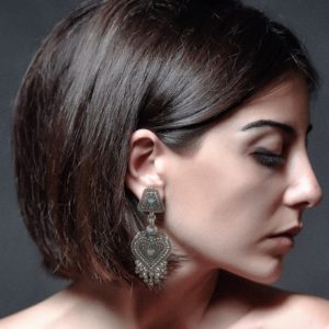 model wearing ethnic rava work turquoise sterling silver earrings